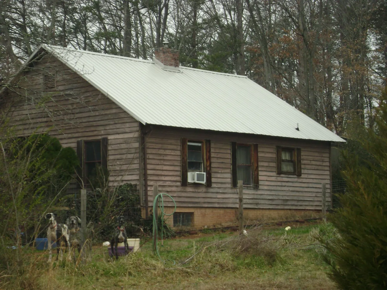 White metal roof on an old wood sided farmhouse, from a Metal Roof Installation job in Spencerport